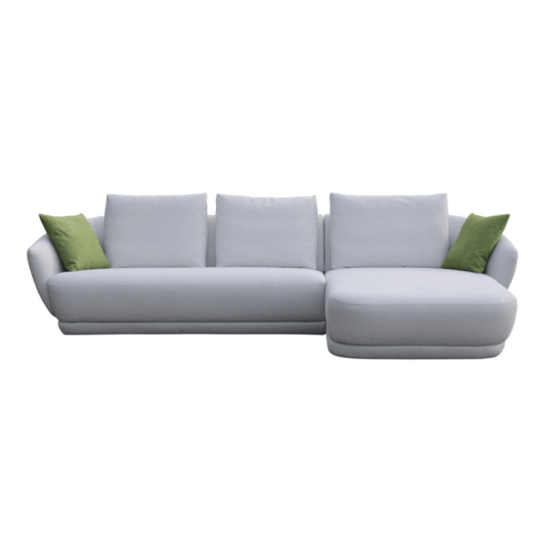 Minimalist gray sectional sofa with soft green pillows.