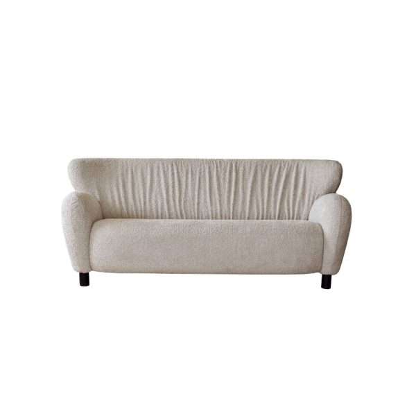 Minimalist beige sofa with a rounded design.