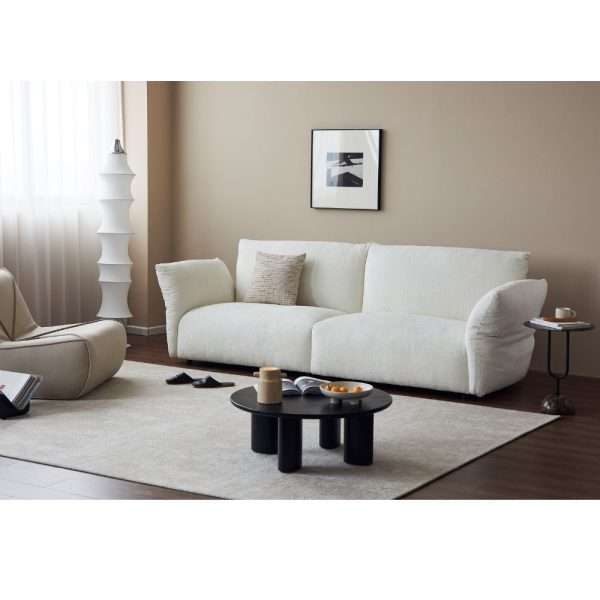 Stylish white sofa paired with a minimalistic living room décor.