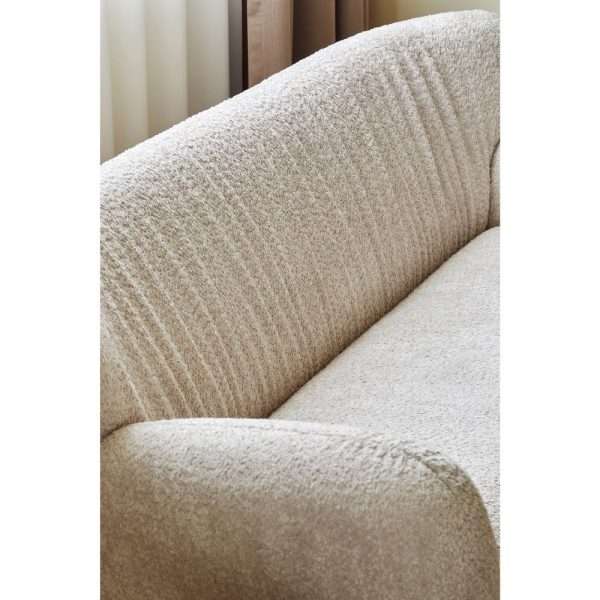 Close-up of the soft textured fabric of a beige sofa