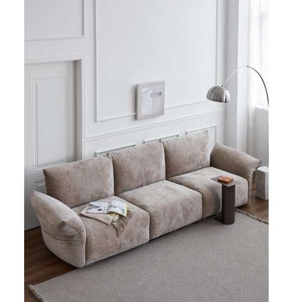 Beige modular sofa in a bright, minimalist living room.